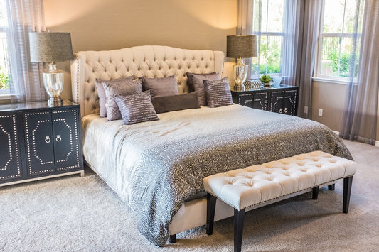 Tall upholstered headboard bed frame in a bright bedroom