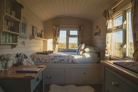 Calm simple bedroom with a low bed beside windows