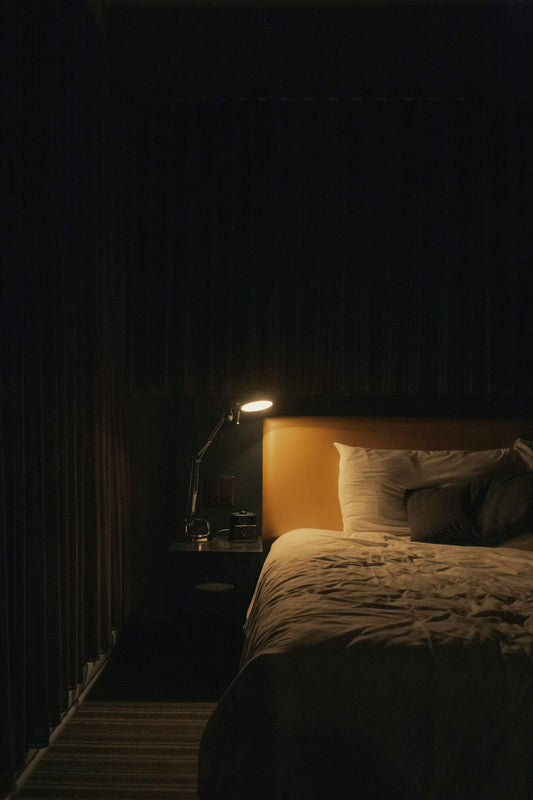 Cosy bedroom with a lamp lit beside the bed