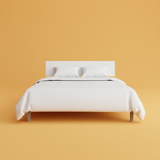 Simple bed with white cover and pillows in a first home bedroom